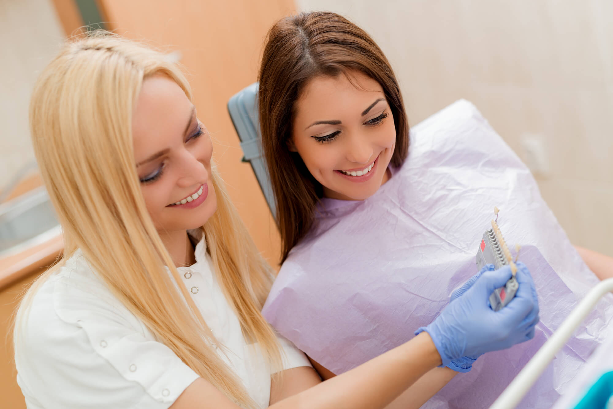 patient and dentist checking the right color for veneers in Tamiami