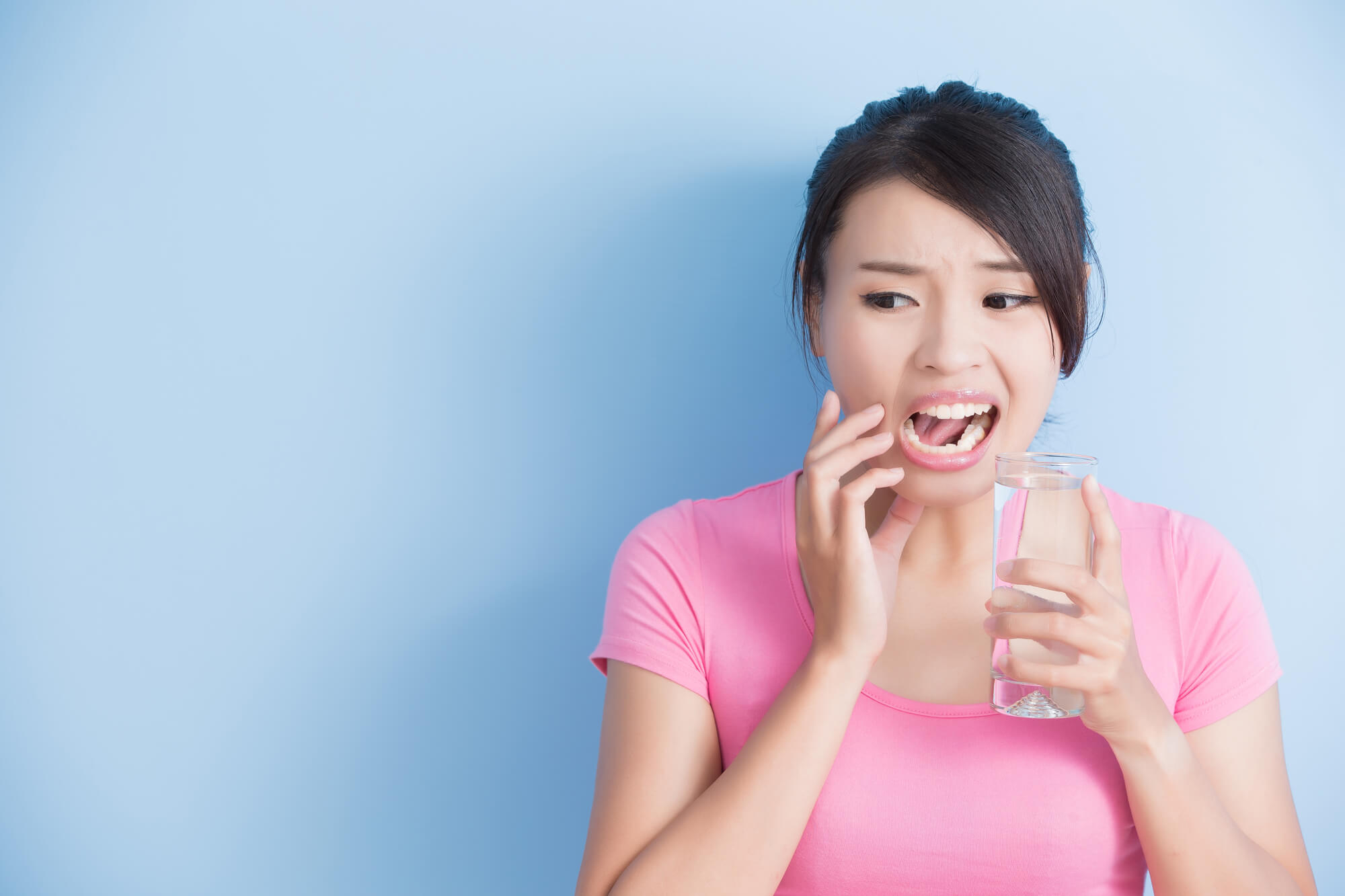 woman with sensitive teeth needing to see a Dentist Near FIU